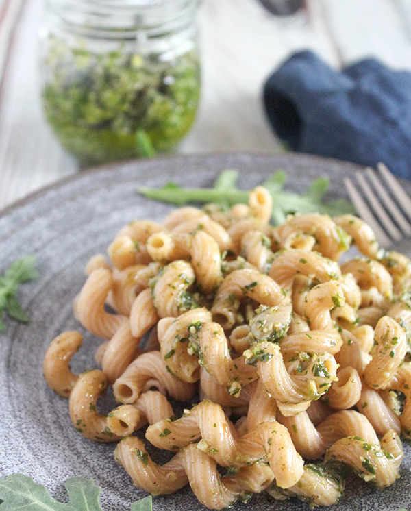 arugula pesto tossed with pasta up close