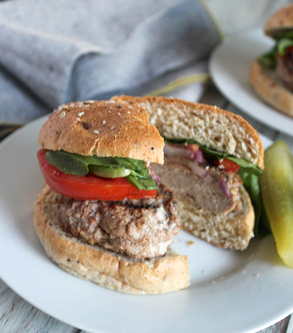 chicken burger cut into half on a white plate