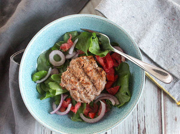 Chicken burger in a bowl on a bed of lettuce