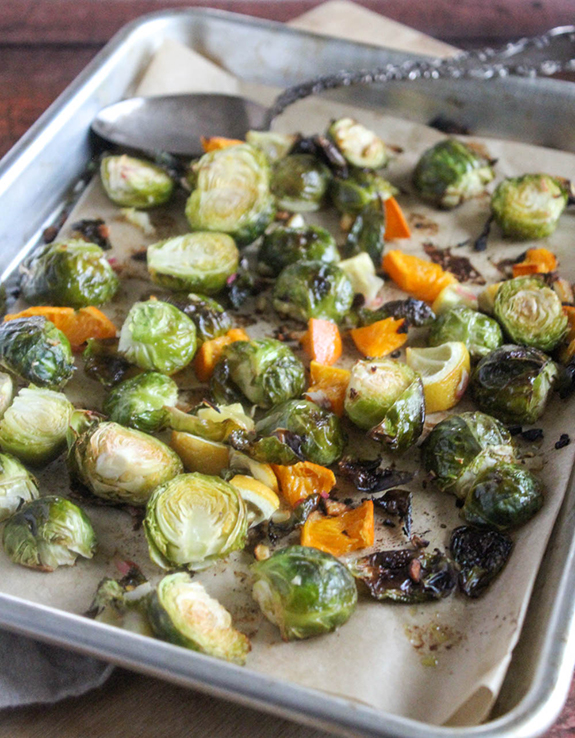 Easy roasted brussels sprouts baked on a sheet pan with a spoon