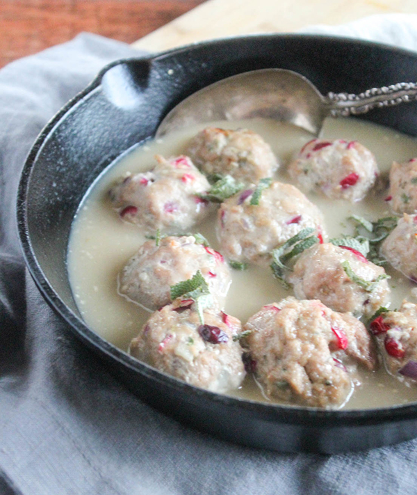 turkey meatballs covered with gravy in a skillet
