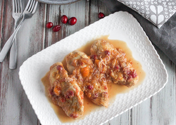 cranberry chicken on a platter with 2 forks