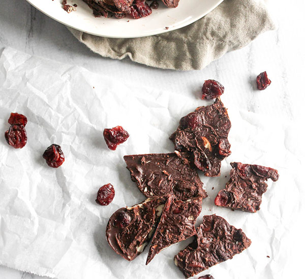 dark chocolate almond bark broken into pieces on parchment paper