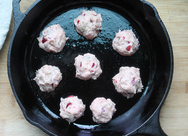 raw turkey meatballs in a skillet