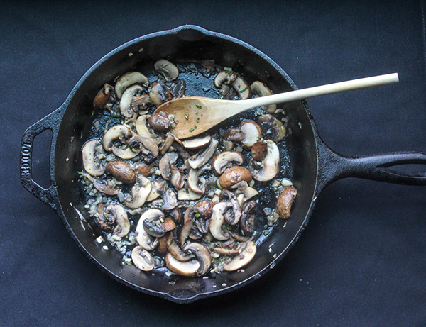 mushrooms cooking in a skillet