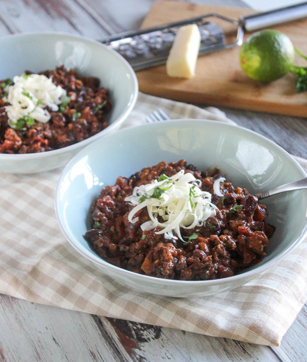 Two bowls of quick and easy chili with cheese on top