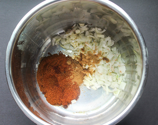 chili spices and onions cooking in a large pot