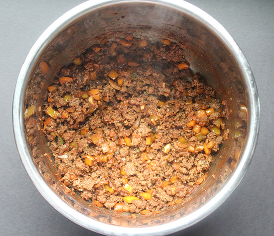 an overhead view of meat chili vegetables and meat cooking