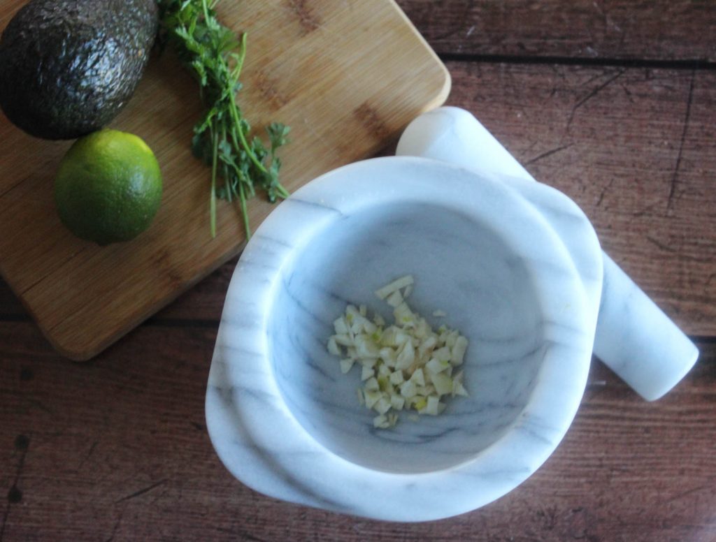 garlic and onions in a mortar bowl