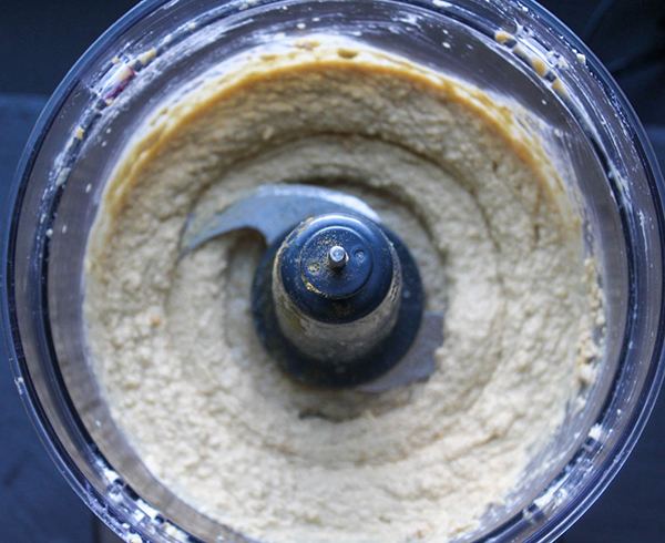 Hummus in food processor bowl after the oil is added and blended