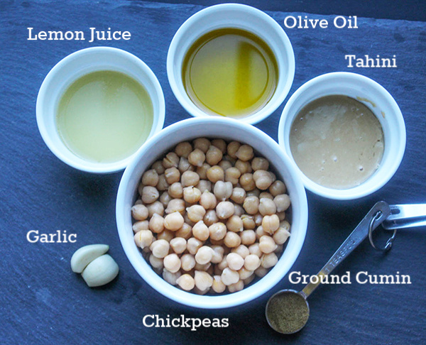 The hummus ingredients, lemon juice, olive oil, tahnin, ground cumin, chickpeas, garlic