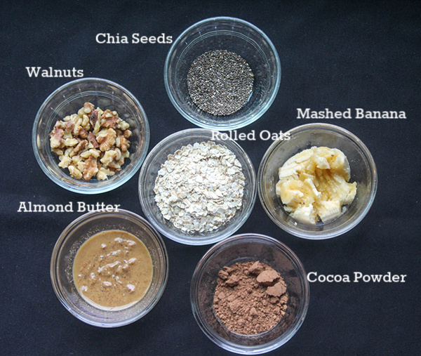 The ingredients; chia seeds, walnuts, rolled oats, banana, almond butter and cocoa powder