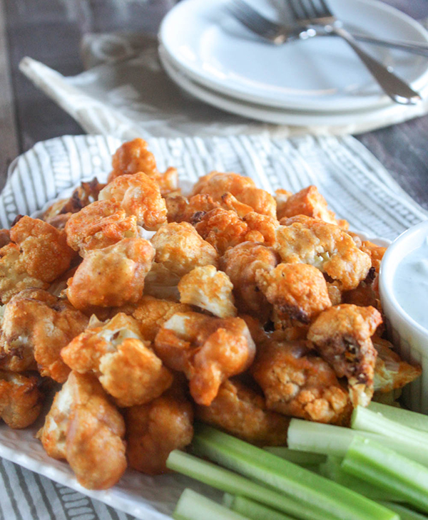 buffalo cauliflower bites on a tray with celery