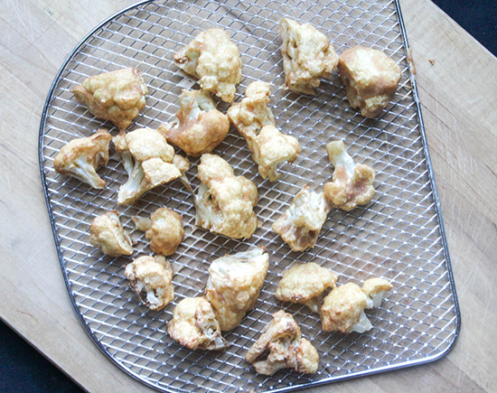 cooked cauliflower on an air fryer tray