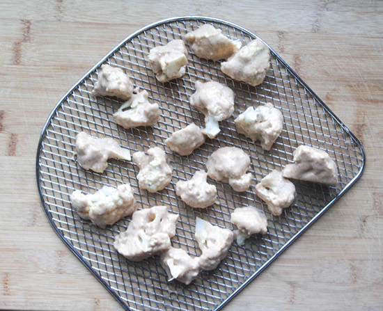 a picture of cauliflower on a basket with batter