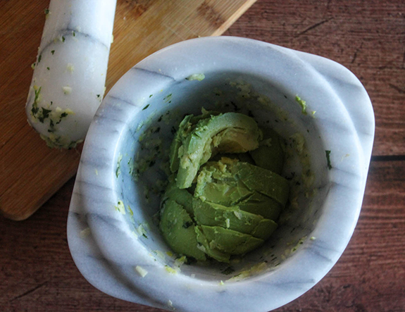 avocado in mortar bowl ready to be mashed