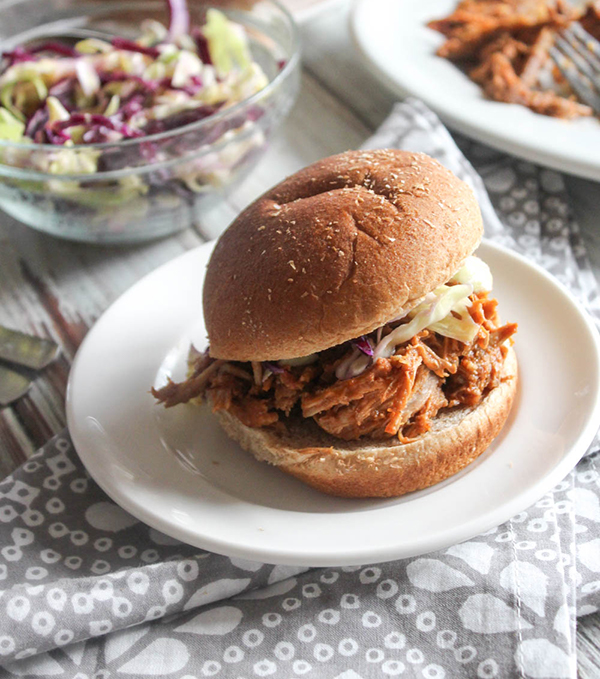 a picture of pulled pork on a roll with coleslaw