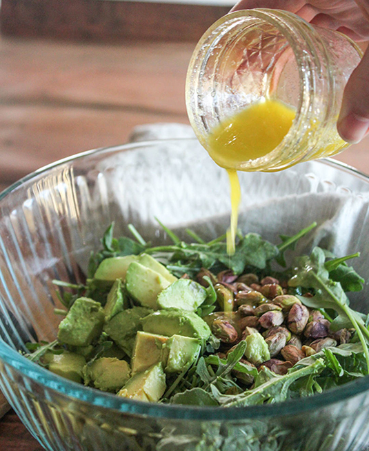 salad dressing pouring over a salad