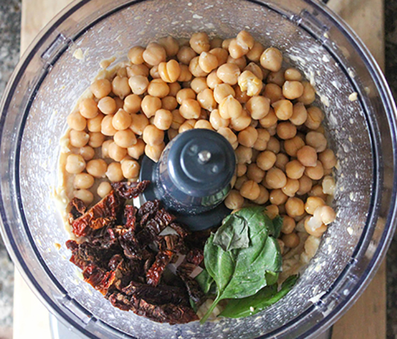 Chickpeas, sun dried tomaotes and basil in a food processor bowl