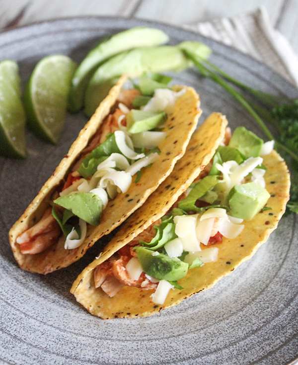 Two taco shells filled with tacos on a plate