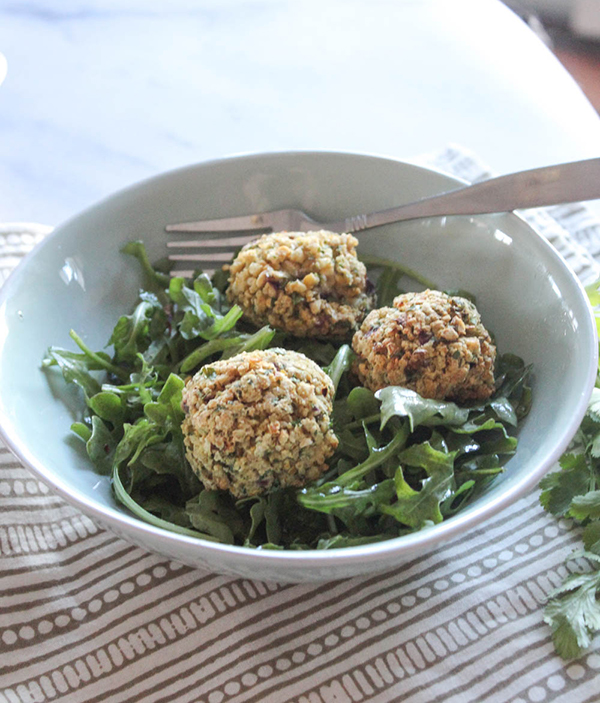 Falafel balls in a bowl with greens