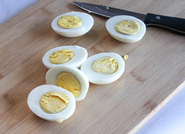 eggs sliced in half on a cutting board