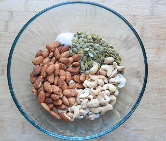 the ingredients in a bowl, almonds, cashews pepitas, sea salt