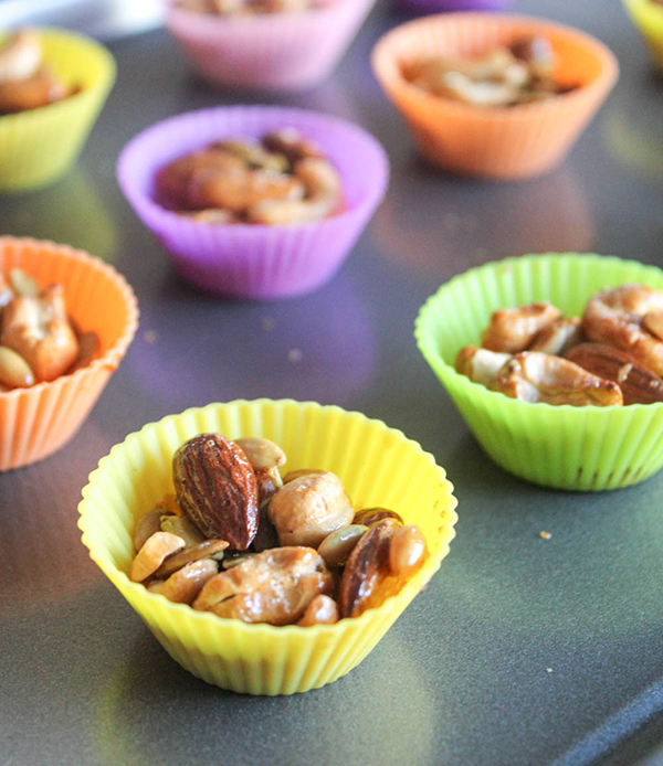 a close up of cashew clusters in a yelow cupcake liner