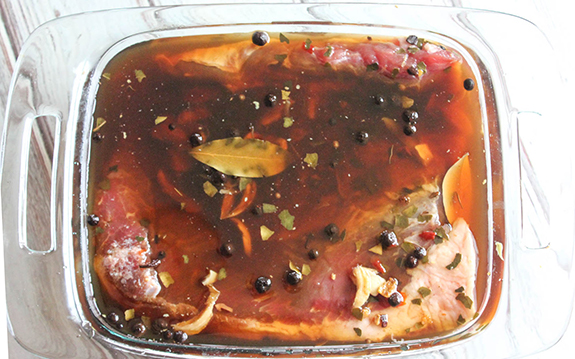 a photo of meat in brine in a glass dish