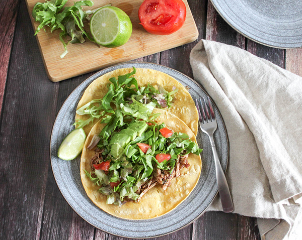 Overhead view of tostadas on a plate with a fork