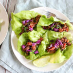 an overhead view of taco lettuce wraps on a white plate