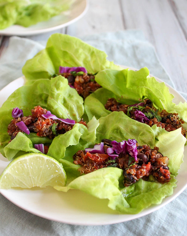 Vegetarian taco lettuce wraps on a plate with lime slices