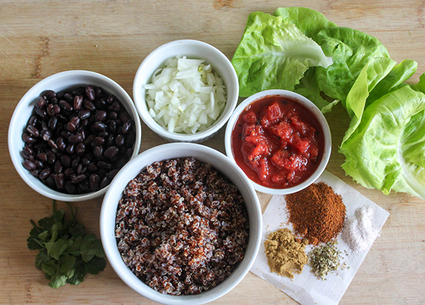 The ingredients, black beans, quinoa, cilantro, spices, tomatoes, onions and lettuce