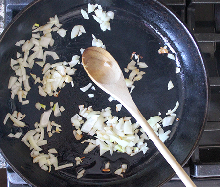 onions in a pan with a spoon