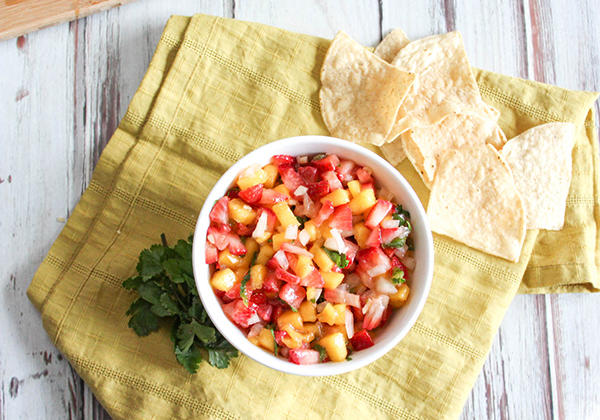 mango and strawberry salsa in a bowl with chips on the side
