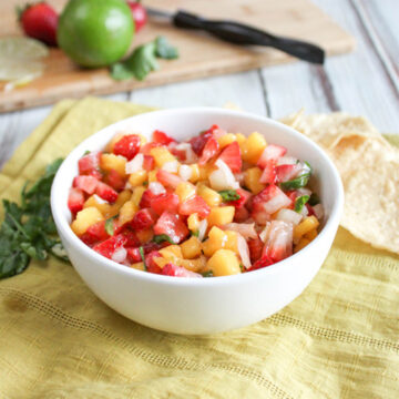 a bowl full of mango and strawberry salsa