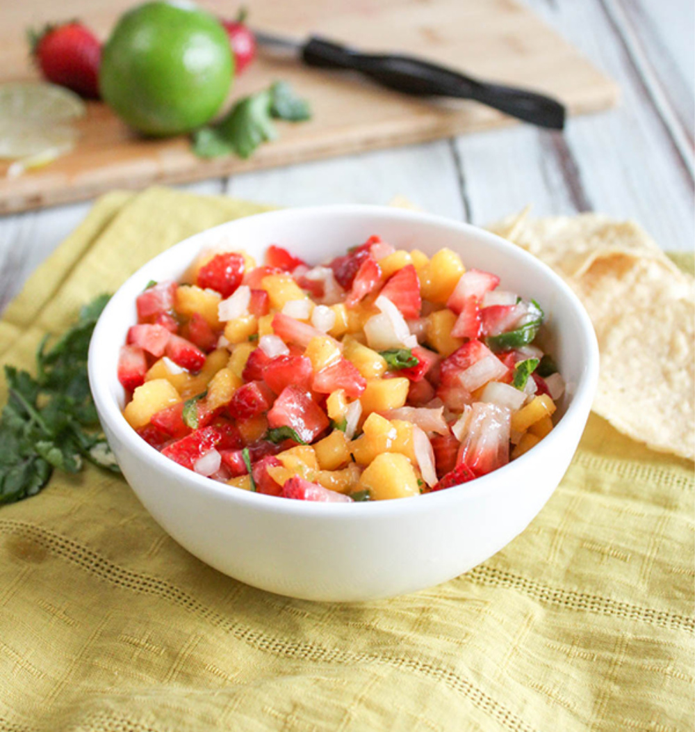 a bowl full of mango and strawberry salsa