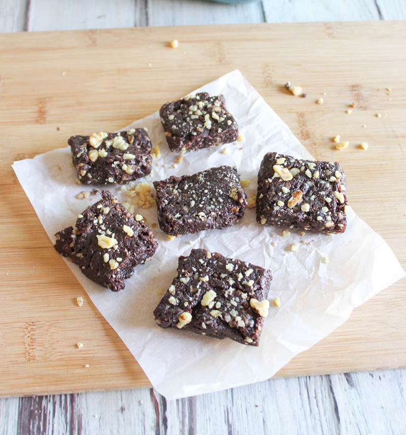 Brownies on parchment paper on a cutting board