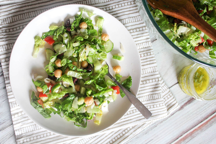 On overhead view of salad on a white plate with a fork