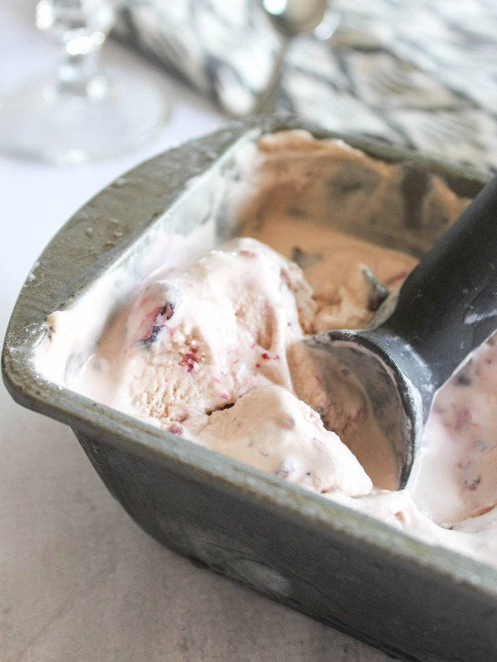 a close up of ice cream in a pan with a scoop