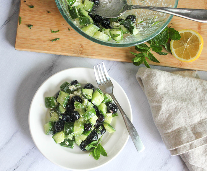 an overhead view of the cucumber salad on a plate with a fork