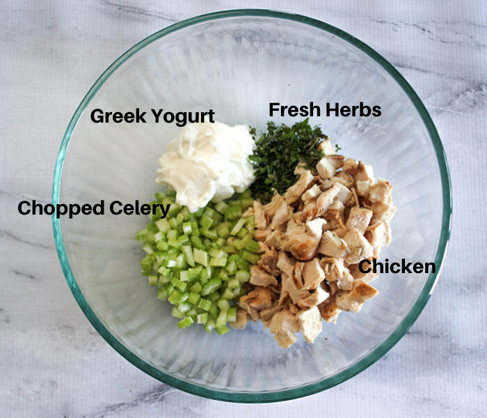 The ingredients in a bowl: Greek Yogurt, Fresh Herbs, Chicken, Chopped celery