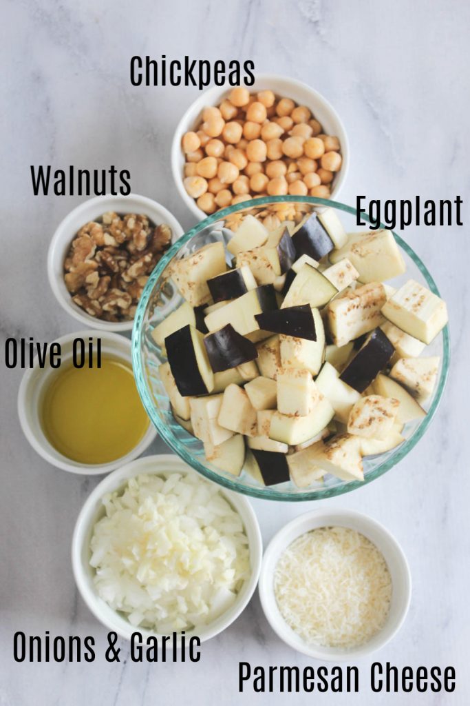 The Ingredients overhead view, chickpeas, walnuts, Olive Oil, onions & garlic, parmesan cheese,  eggplant chunks