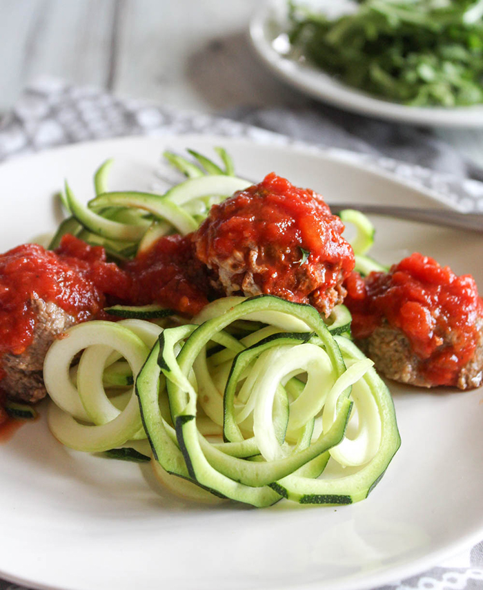 Eggplant meatballs on top of zucchini noodles topped with red sauce