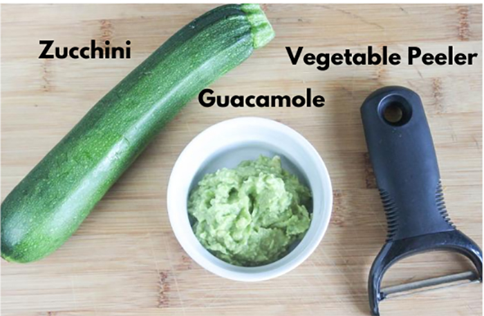 a picture of the ingredients to make these zucchini rolls: guacamole and zucchini