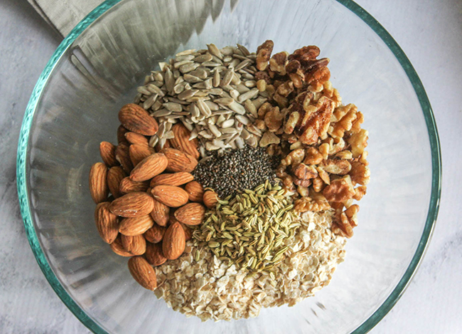 a picture of the granola ingredients in a mixing bowl