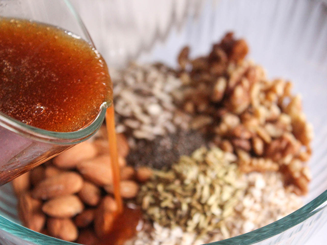 A picture of wet ingredients pouring over the dry ingredients.