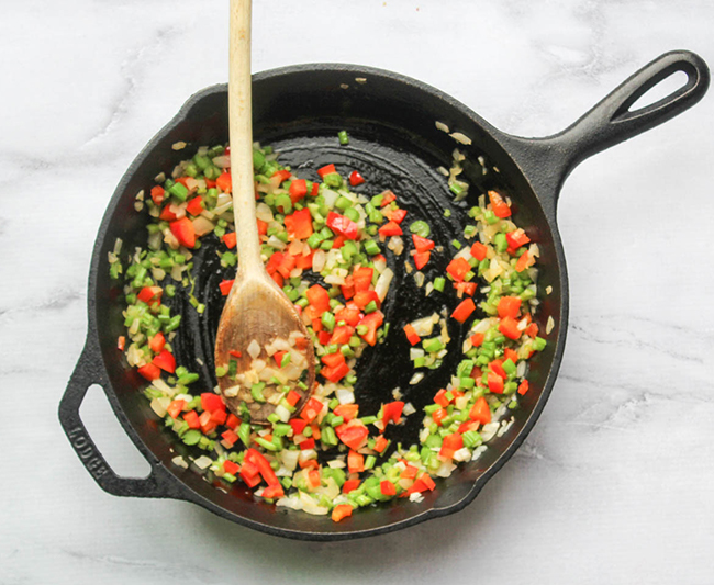 celery onions and peppers cooking in a skillet