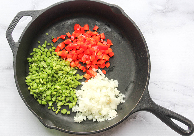 celery onions and bell peppers chopped in a skillet