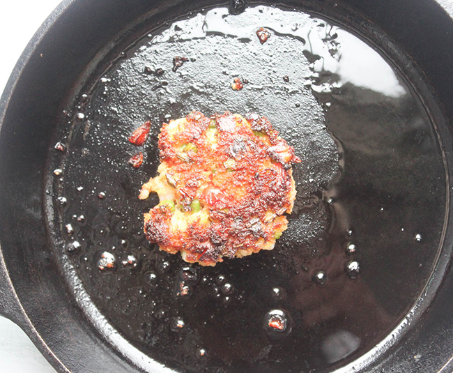 shrimp cake cooking in a skillet